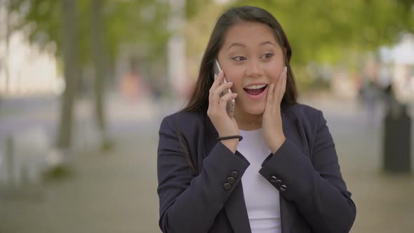 Excited Young Woman Talking By Cell Phone Outdoor