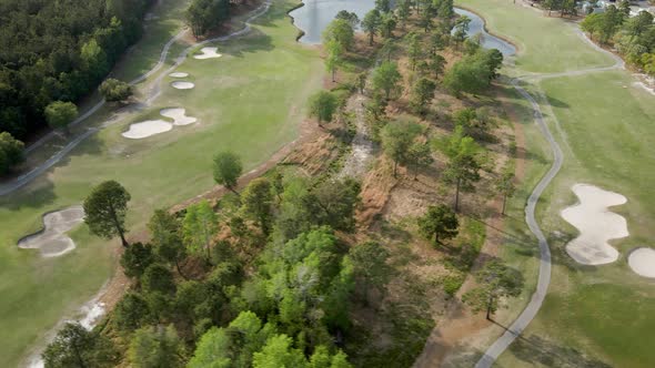 Aerial over Magnolia Greens golf course slow orbiting parallax