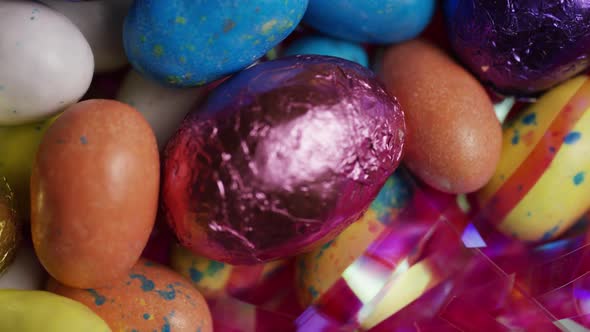 Rotating shot of colorful Easter candies on a bed of easter grass 