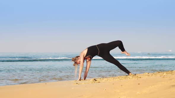 Lady in Black Tracksuit Practices Advanced Yoga Pose