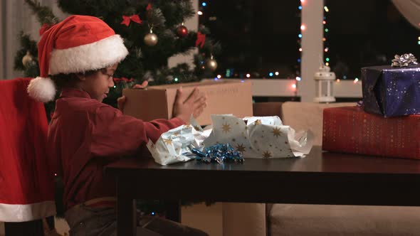 Black Boy Opening Christmas Present.