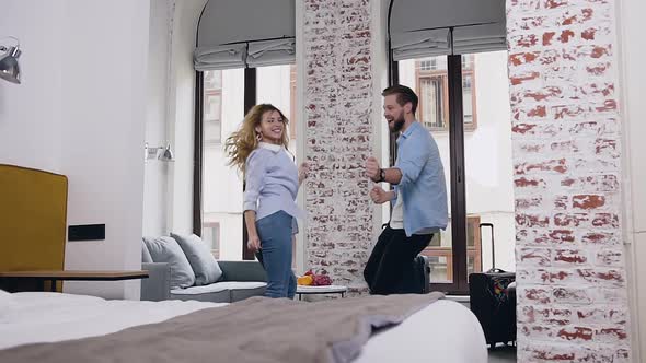 Modern Couple Dancing Together Like as Rock and Roll and then Hugging and Having Fun in Hotel Room