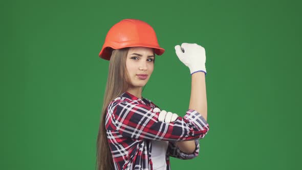 Confident Sexy Female Constructionist Showing Her Biceps We Can Do It Gesture