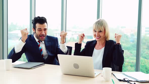 Two Happy Business People Celebrate at Office