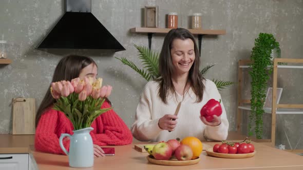 Mother Talks to Her Daughter While She Prepares the Vegetable Salad