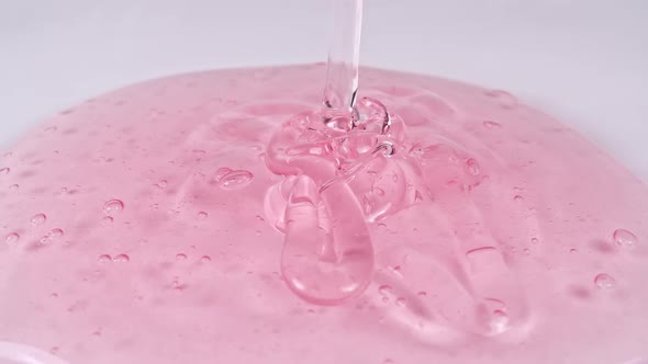 Pouring the Red Cosmetic Gel Cream With Molecule Bubbles