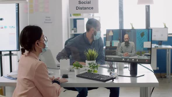 Freelancer with Protective Face Mask Talking with Collegue During Virtual Videocall Conference