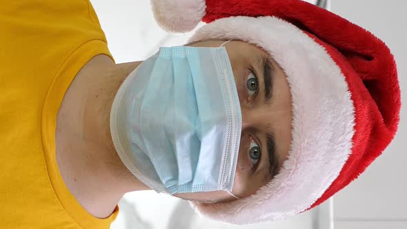 Man in Santa Hat Wearing Medical Mask Celebrate Christmas Alone at Home