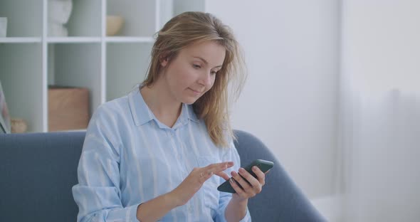 Portrait of Happy Business Woman Enjoy Success on Mobile Phone at Home Office. Closeup Joyful Girl