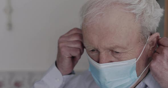 Happy Grandfather Taking Off Mask After Recovering From a Virus and Breathing