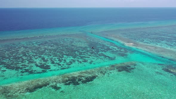 Wide birds eye copy space shot of a white paradise beach and aqua blue ocean background in colourful