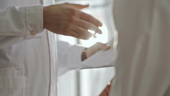 Scientists in Lab Coats Shaking Hands