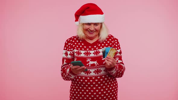 Christmas Grandmother Using Credit Bank Card Smartphone While Transferring Money Shopping Online