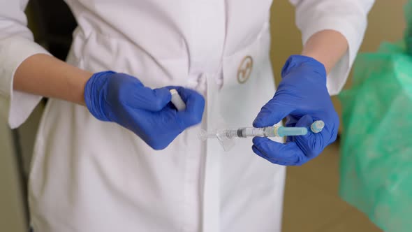 Doctor Cosmetologist Changing Needle on Syringe in Beauty Clinic