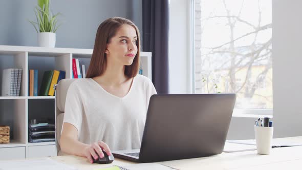 Young Woman Works at Home Office Using Computer.