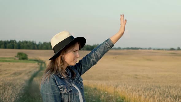 Young Woman Waving Hand For Somebody