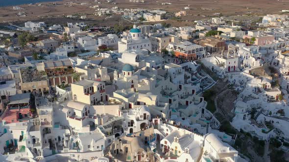 Aerial shot of famous Oia village in Santorini at sunrise in Greece