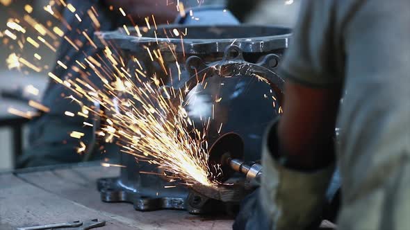 Workers wearing industrial uniforms and Welded Iron Mask at Steel welding plants, industrial safety