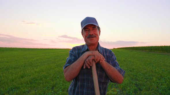 Portrait of a Cheerful Male Worker with Mustache in Agricultural Farm
