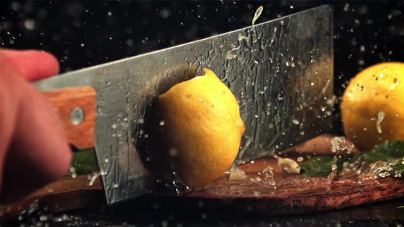 The Lemon is Cut Into Halves with a Large Knife