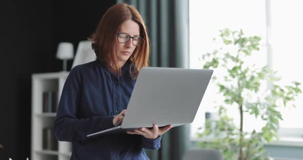 Woman Standing with Laptop