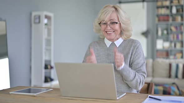 Surprised Old Woman Celebrating Success on Laptop in Office