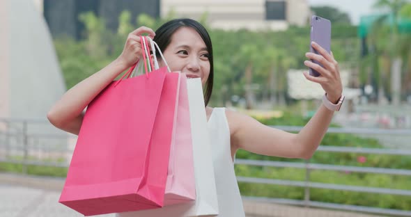 Woman Make Video Call on Cellphone with Holding Lots of Shopping Bag