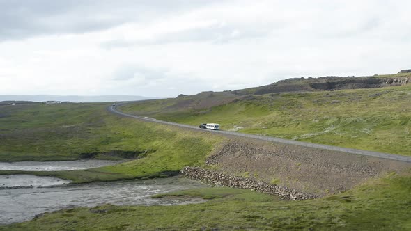 Vehicles Traveling Down The Asphalt Road At The Rural Landscape Of West Fjords In Iceland. aerial