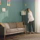 Girl in White Sweater Wipes Dust From Furniture - VideoHive Item for Sale