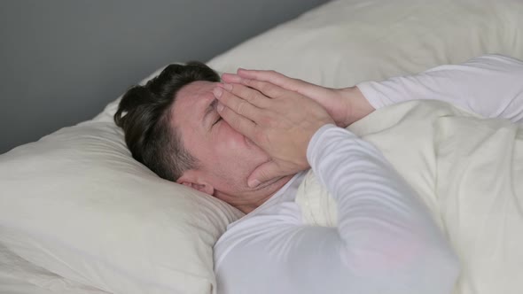 Upset Middle Aged Man Crying in Bed 