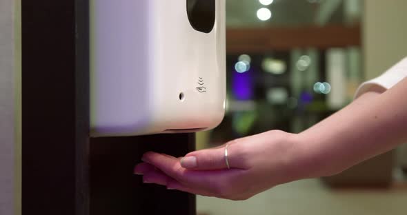 Close Up Woman's Hands Using the Hand Sanitizer To Prevent the COVID Infection