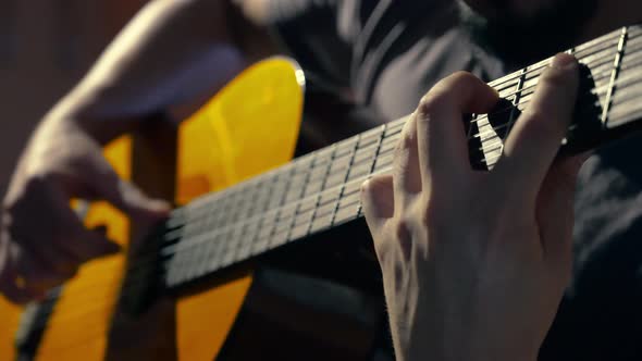 Young man playing dexteriously classical guitar with advance technique in both hands