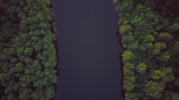 Aerial Video of the Lake on a Warm Summer Day in Light of the Setting Sun