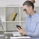 Young Casual Girl Using Smartphone While Working on Computer - VideoHive Item for Sale