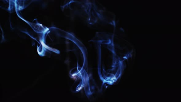 Abstract blue color smoke with a black background in slow motion. Realistic cloud smoke with a strea