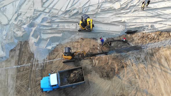 Aerial View Machinery on a Construction Site. Construction Work with the Help of Tractors and Other