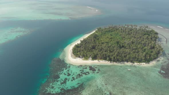 Aerial: flying over tropical island white beach caribbean sea turquoise water