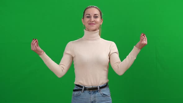 Portrait of Relaxed Young Woman Meditating Looking at Camera and Closing Eyes