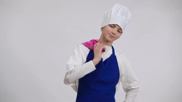 Little Proud Cook Sighing Hanging Towel on Shoulder Looking at Camera Smiling