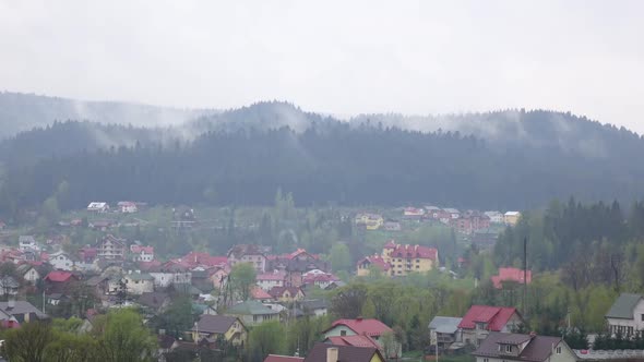 Time Lapse of Cloudy Morning in Small Town in Mountains