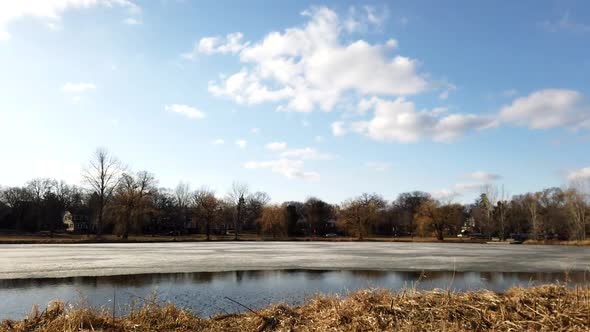 Time-lapse of clouds moving over the lake in the blue sky during a spring afternoon. Lake of the isl