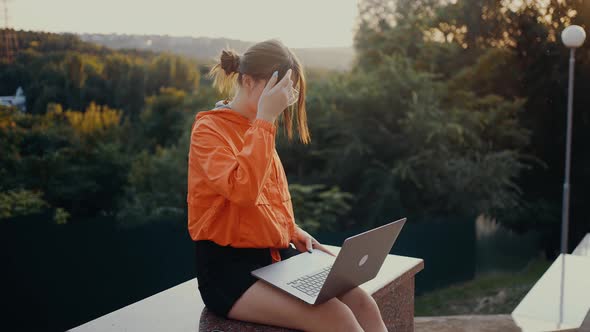 The Ambitious Young Woman with Glasses That Opens the Laptop and Starts Typing