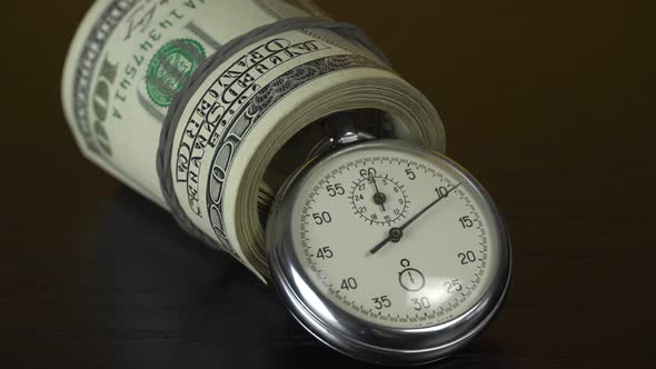 Dollars and stopwatch. Business concept of lost time and failed investments