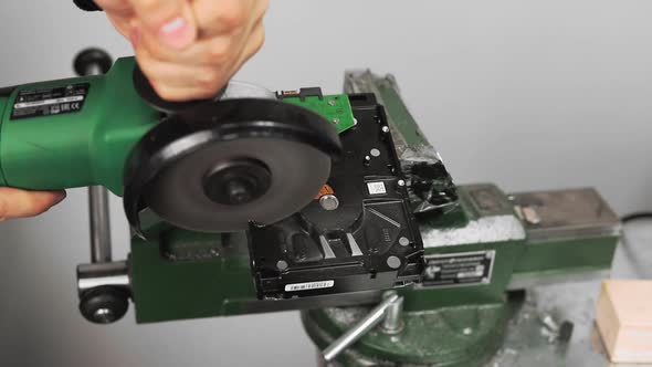 Worker Cuts Open Hard Disk Drive with Circular Saw in Studio