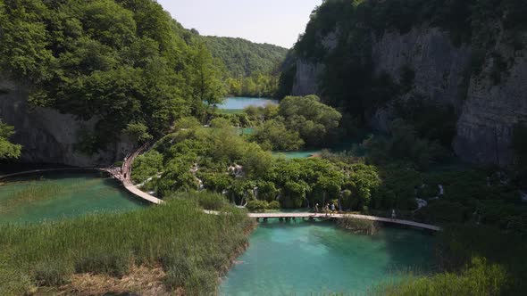 View from above of the Plitvice Lakes National Park with green plants and beautiful lakes and waterf