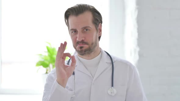 Portrait of Young Doctor Showing Victory Sign with Finger