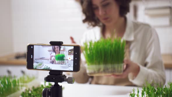 Healthy Food Blogger Girl Talking While Recording Video Green Sprouts, Vlog Concept, Women