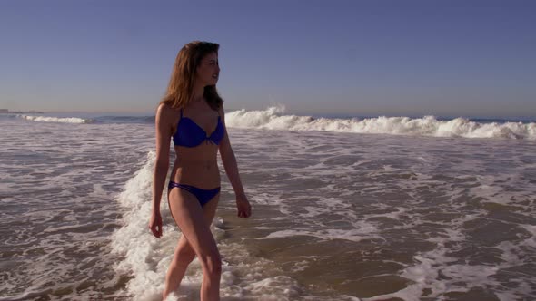 Woman Walking On The Beach