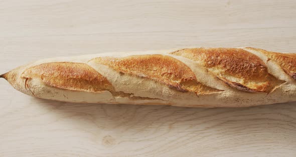 Video of close up of baguette on a black surface