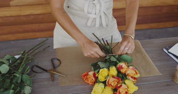 Florist preparing flower bouquet alt